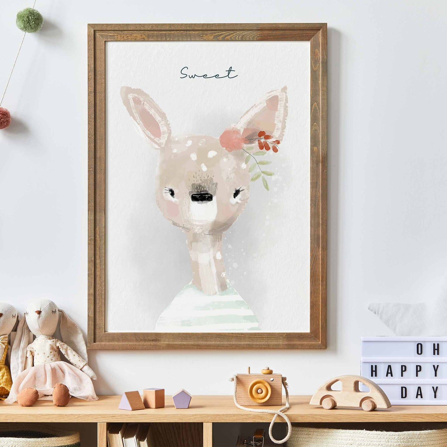 An oak frame of a cute whimsical deer with inspirational quote decorated in a kids room