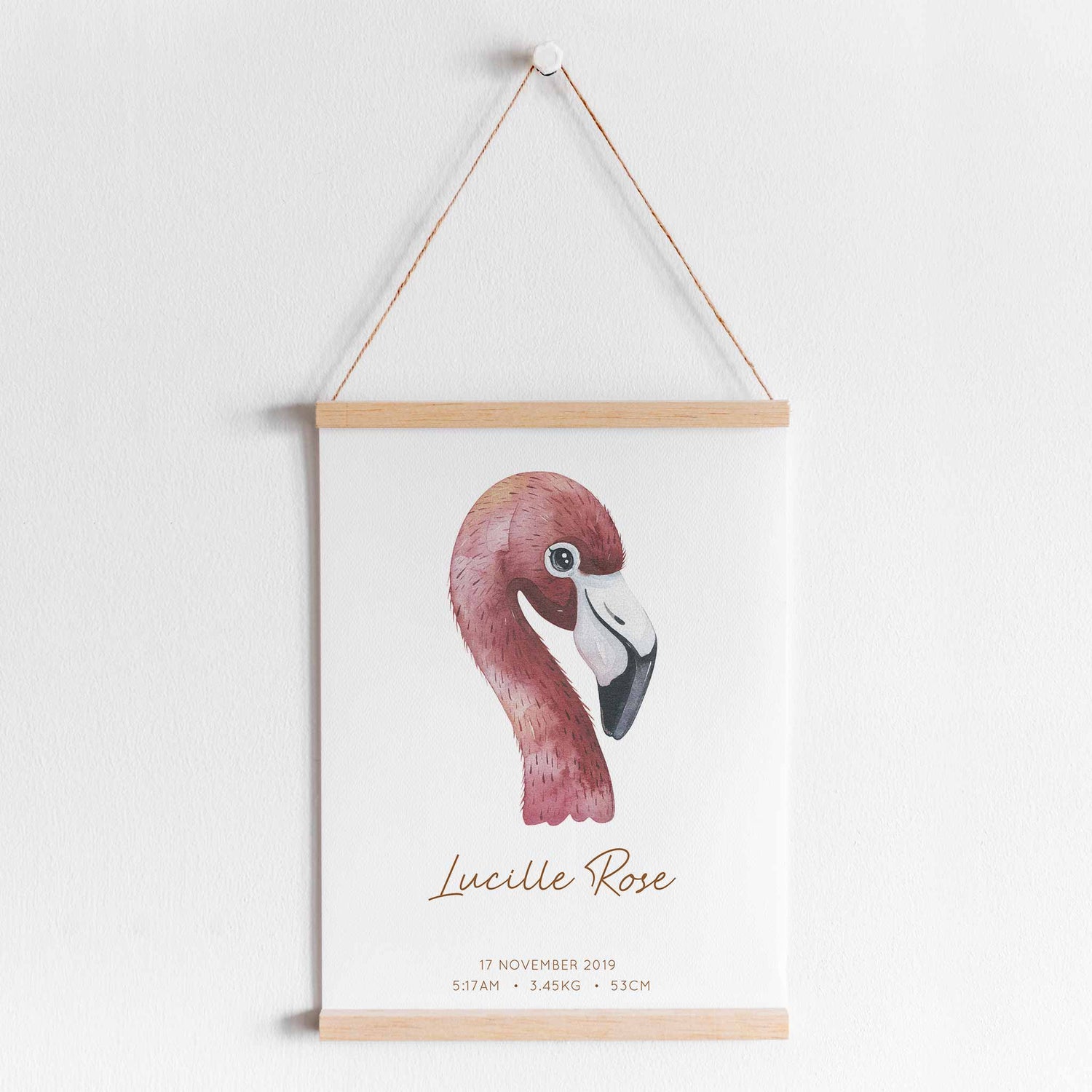 A hanging frame of a watercolour flamingo kids personalised birth print