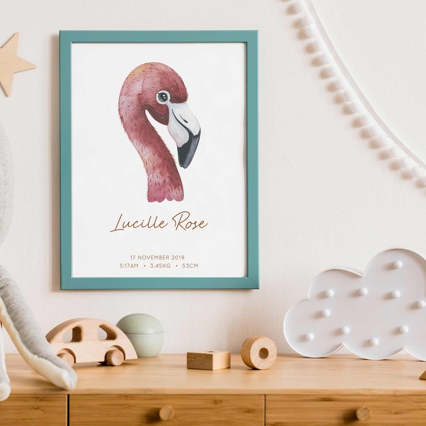 Framed picture of a watercolour flamingo kids personalised birth print in a child's nursery