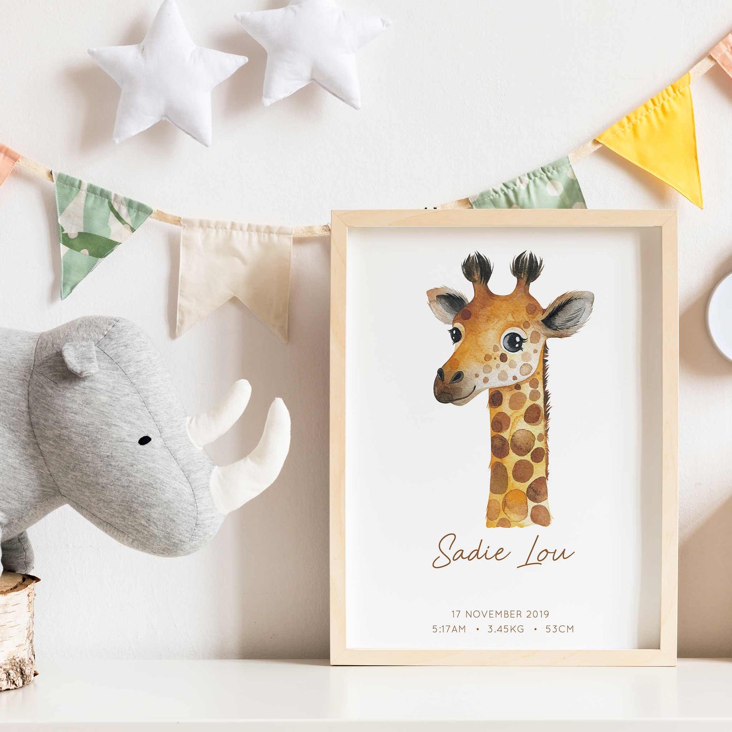 Framed picture of a watercolour giraffe kids personalised birth print in a child's nursery