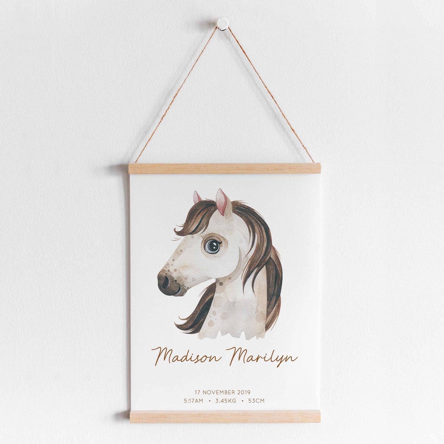 A hanging frame of a watercolour horse kids personalised birth print