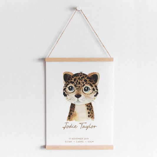 A hanging frame of a watercolour leopard kids personalised birth print