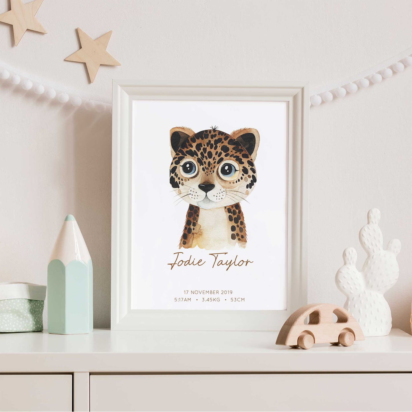 Framed picture of a watercolour leopard kids personalised birth print in a child's nursery