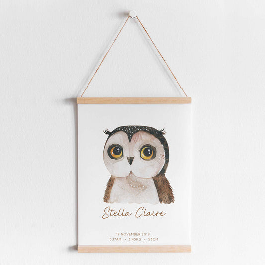 A hanging frame of a watercolour owl kids personalised birth print