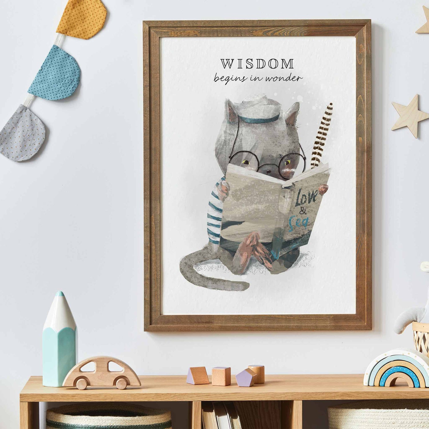 An oak frame of a cute whimsical cat with inspirational quote decorated in a kids room