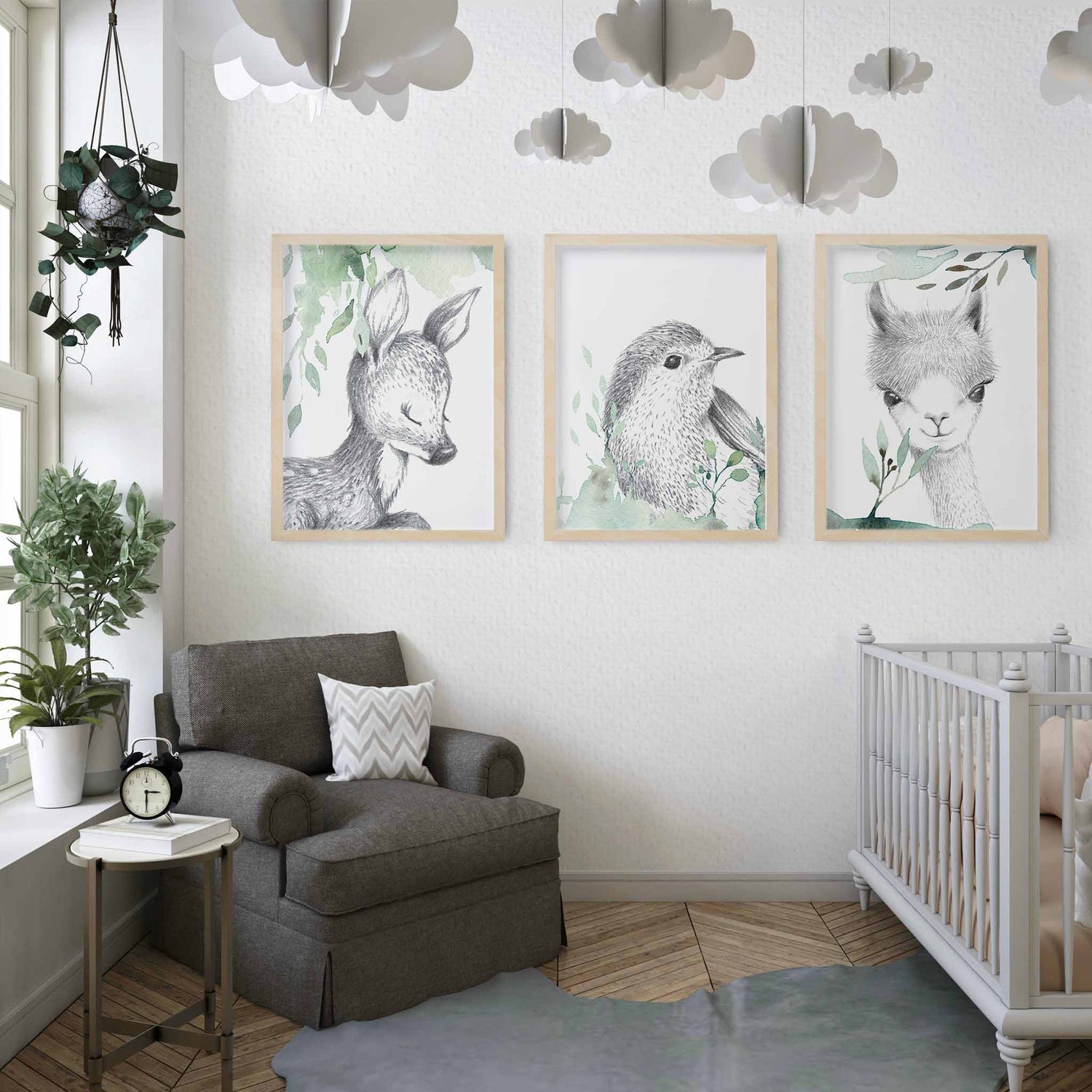 A set of 3 framed images of woodland deer, bird and llama sketch foliage nursery kids print decorated in a nursery