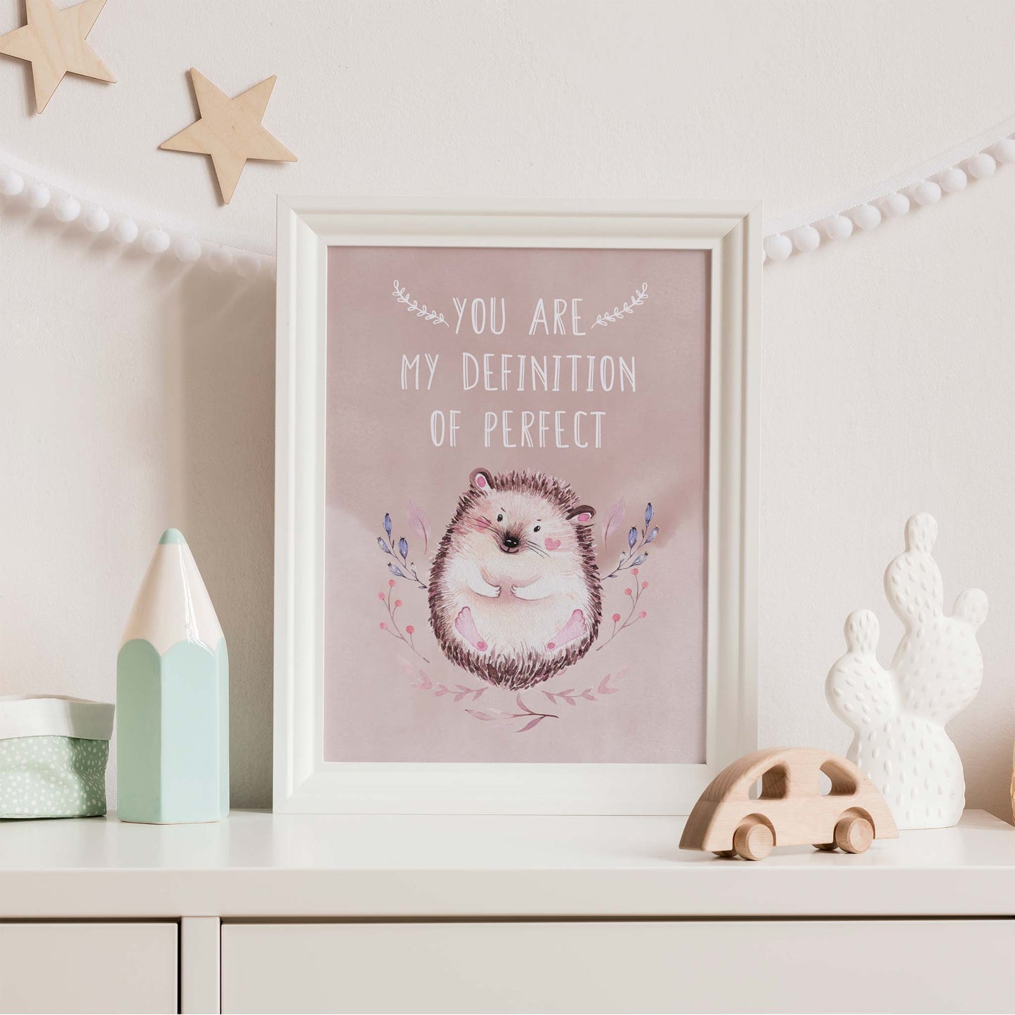 An white frame of a cute woodland hedgehog with inspirational quote decorated in a living room